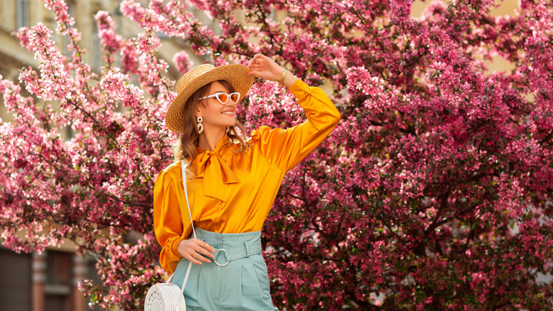 woman standing by pink tree