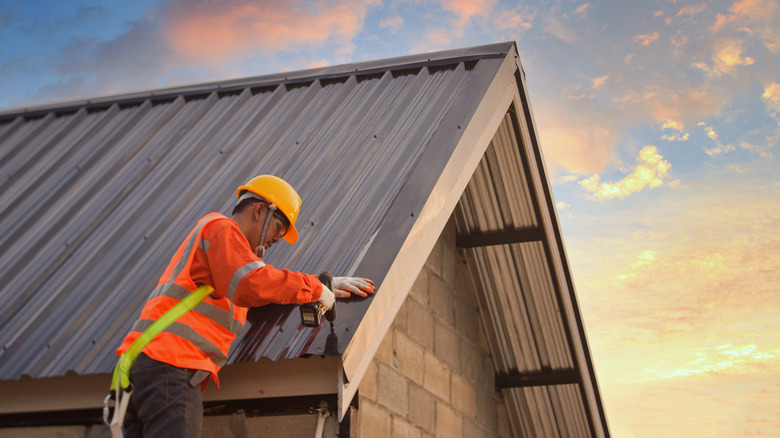 Contruction worker installing roof