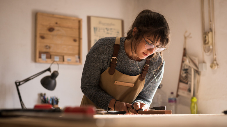 female carpenter working wood