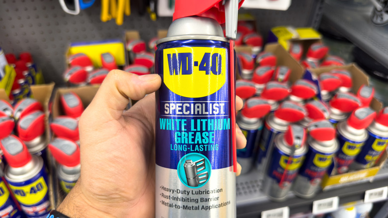 Close-up of a person spraying leather shoes with WD-40