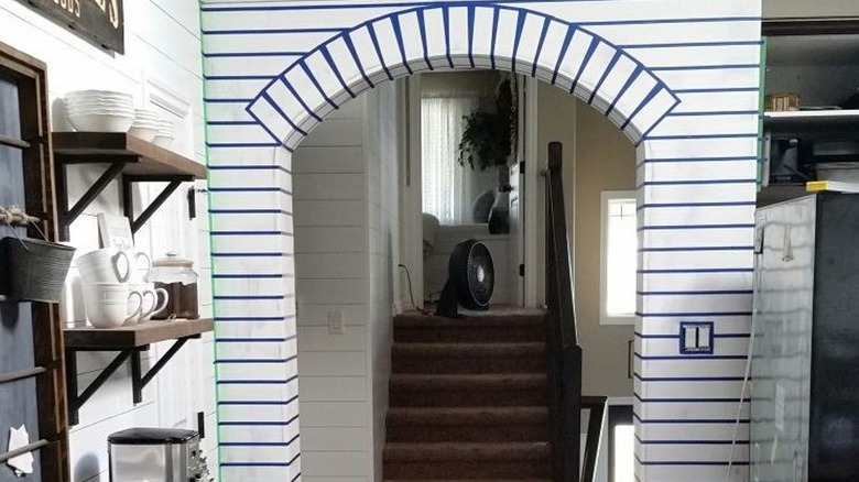 Blue and white striped archway of a kitchen