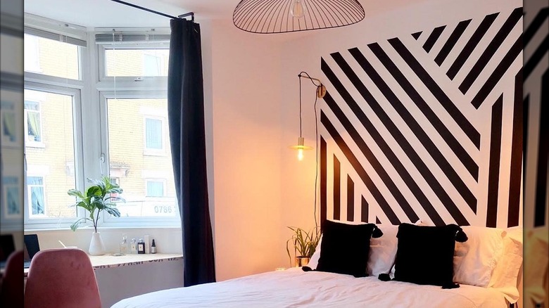 Painted stripes behind a bed