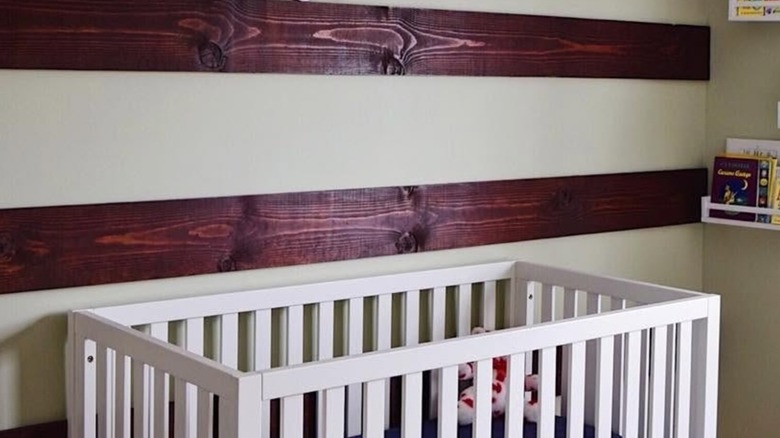 Nursery with horizontal wood planks on the wall