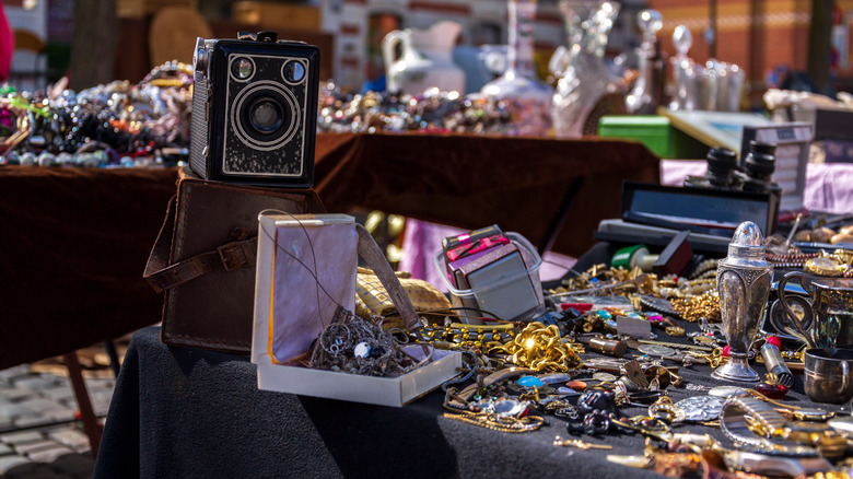 Vintage trinkets and camera on a table at an estate sale