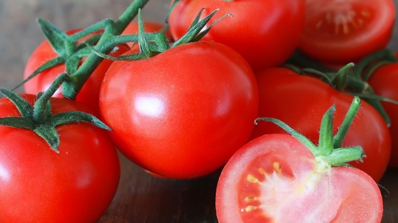 'Siberian' tomatoes cut and whole on the vine