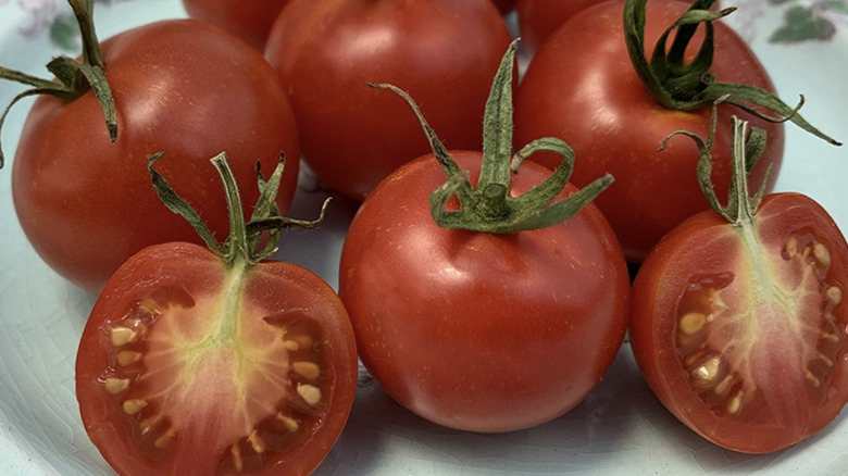 'Stupice' tomatoes whole and cut in half on a plate