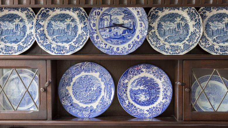 Beautiful plate collection on wooden cabinet