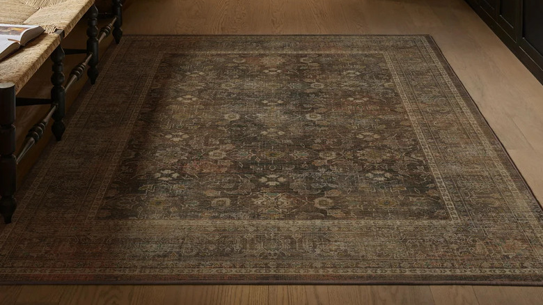 Faded-looking Persian-style floral rug in shads of brown and beige