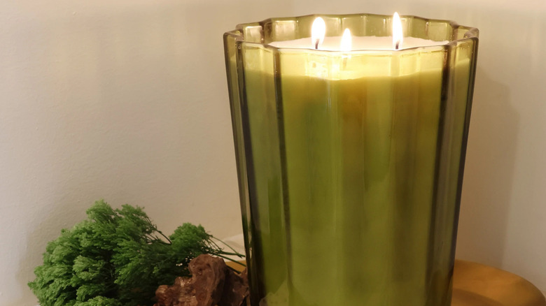 Amber and green-tinted glass candles with scalloped edges