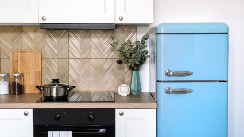 A kitchen with a blue fridge.