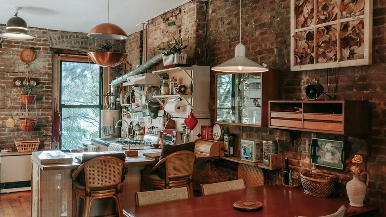 A ktichen with vintage elements like exposed brick, pendant lighting, and retro decor.