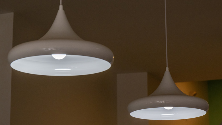 A pair of white, cone-shaped drop pendants on the ceiling.