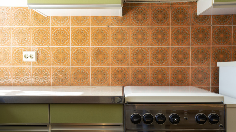 A close up of a retro kitchen with a bold tile backsplash.