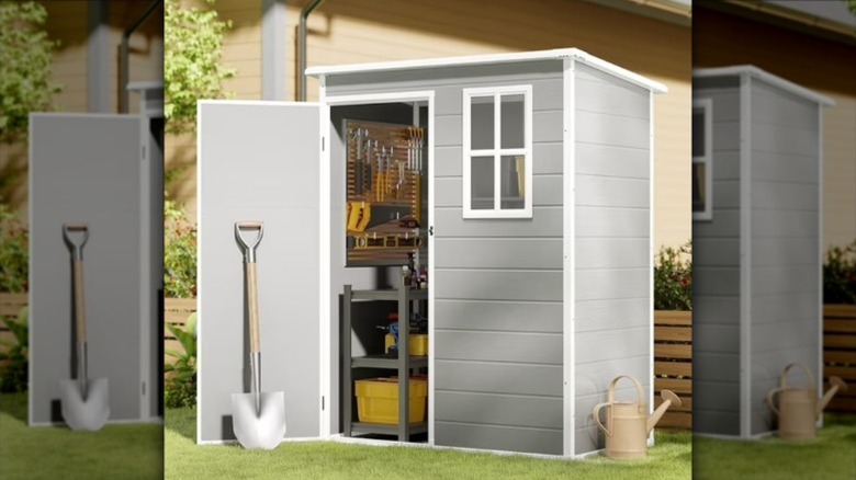 The plastic Asofer shed filled with tools.