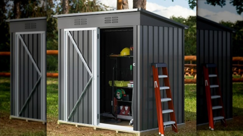 The dark gray UFORIC shed with swinging doors.