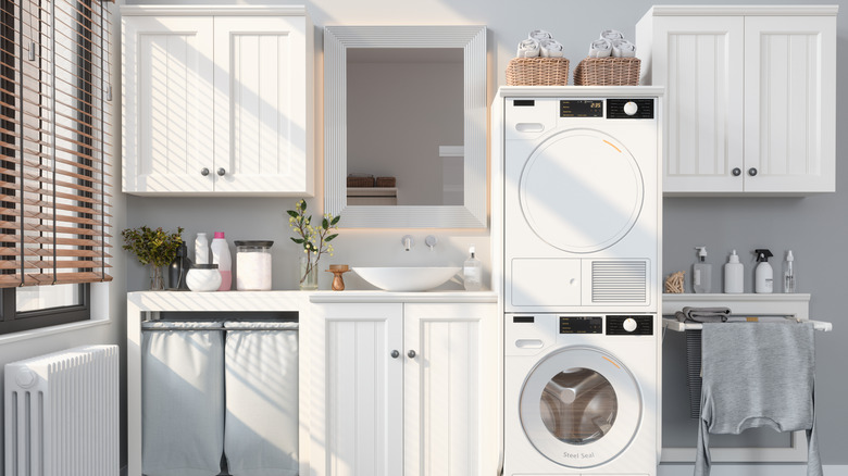 A contemporary laundry room with baskets on top of the dryer