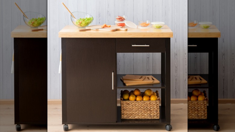 A kitchen island cart with wooden countertop