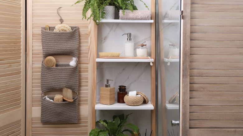 A bathroom with a set of rope hanging baskets on the wall