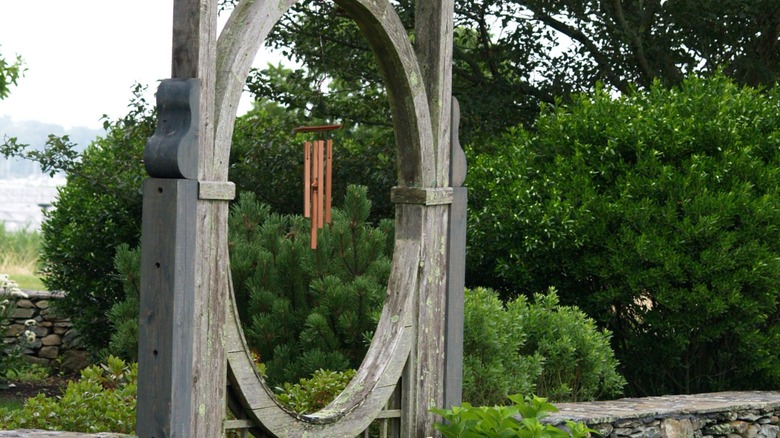 A windchime hanging from a wooden arch