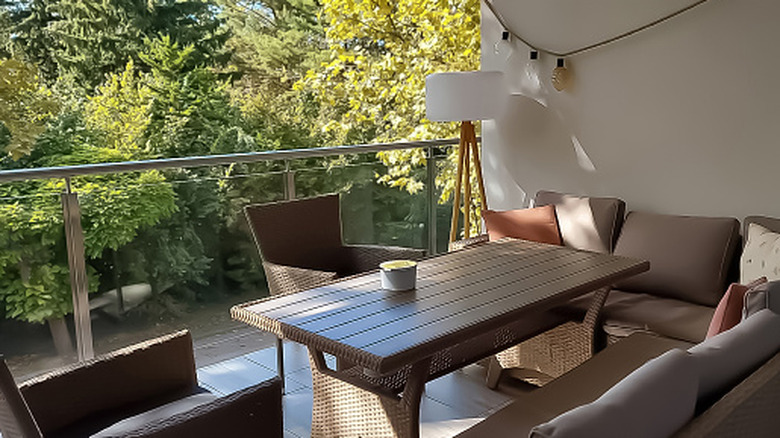 Balcony with a patio dining table and an outdoor floor lamp