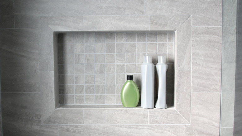 Gray shower niche with bottles