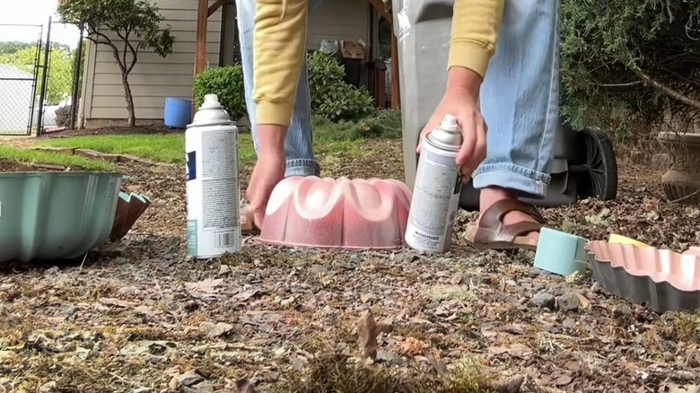 person hitting pan with wood