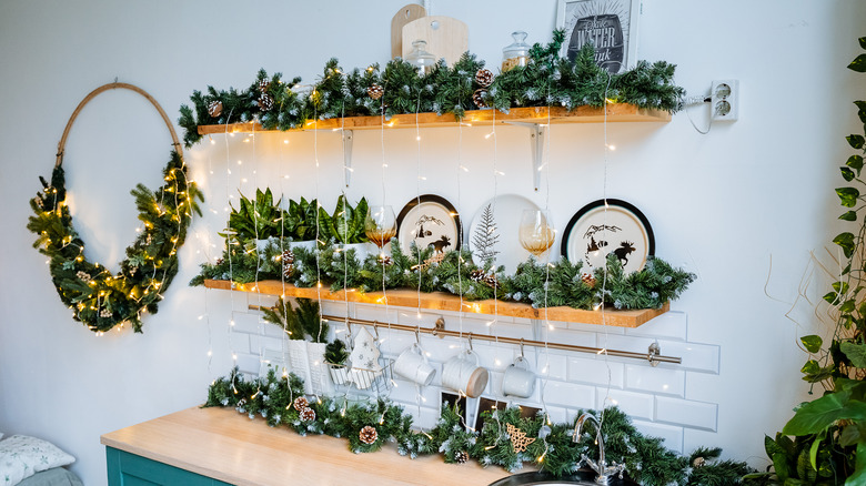 plate shelf decorated with Christmas garland