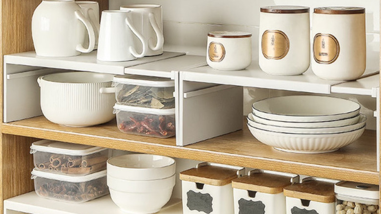 white dishes stacked on shelves