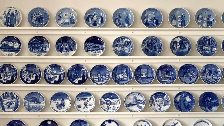 Rows of blue and white china plates on shelves