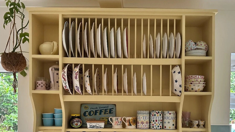 Kitchen plate rack filled with plates cups, and bowls