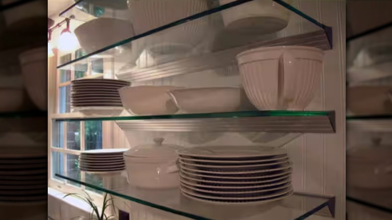 glass shelves with dishes in a window