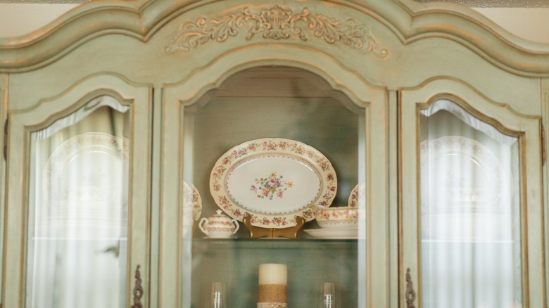 A china cabinet with windows to display china