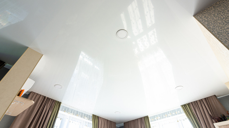A ceiling painted in glossy white paint