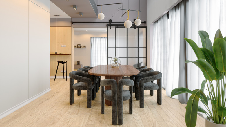 A modern dining room with a wall of windows