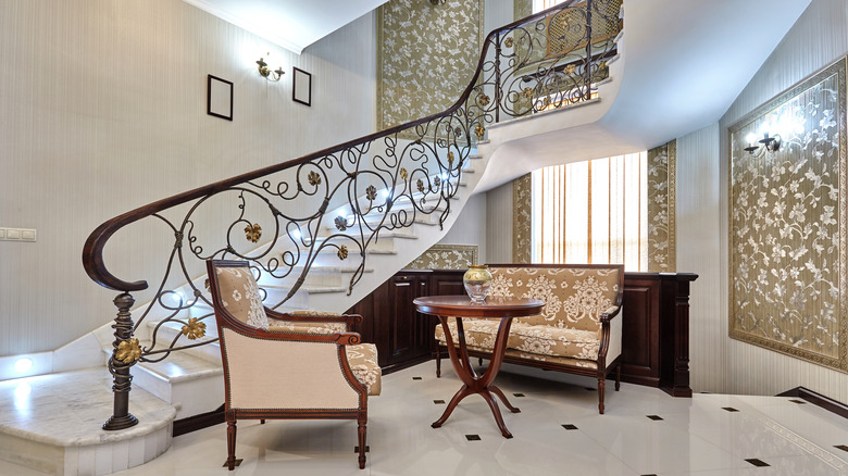 staircase with metal grapevine balustrade