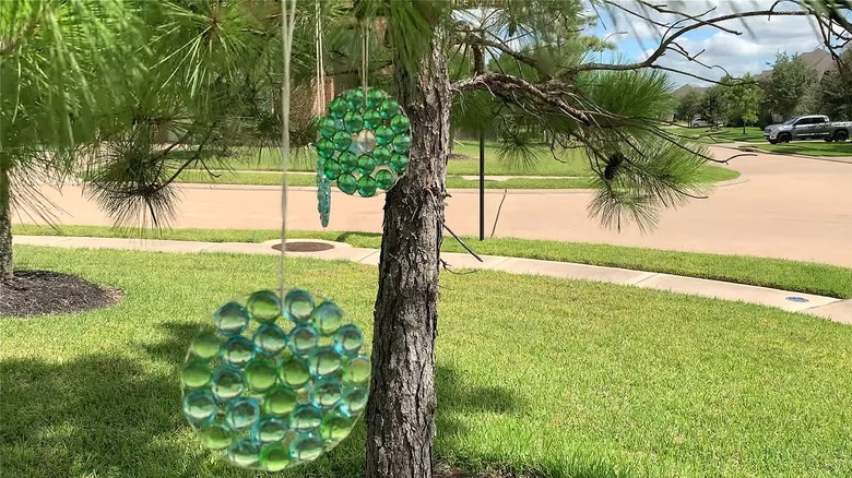 Gem suncatchers hanging outside from a tree branch