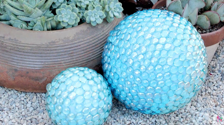 A small and large gazing ball made from Styrofoam balls covered in gems