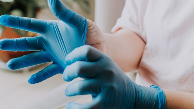 Removing blue rubber gloves