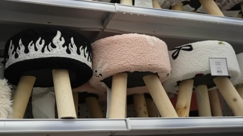 Printed fabric footstools on shelf