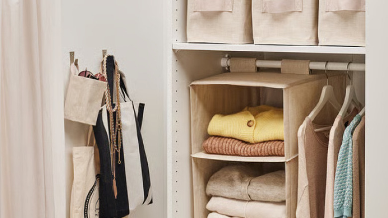 Small linen bag organizer hanging in neutral tone closet with other clothing and accessories