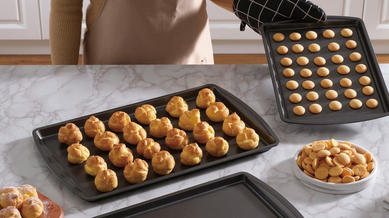 Three different cookie sheets with cookie dough