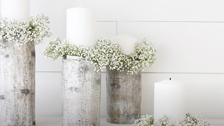 White pillar candles with baby's breath wreaths