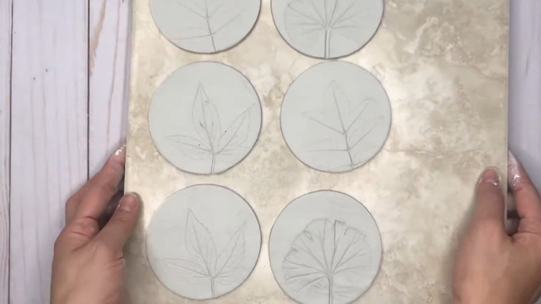 Clay coasters with leaf textures imprinted on them