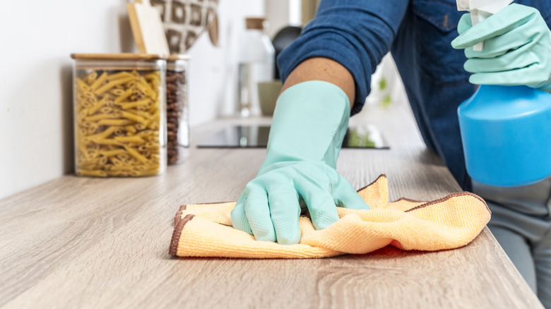gloved hand wipes counter