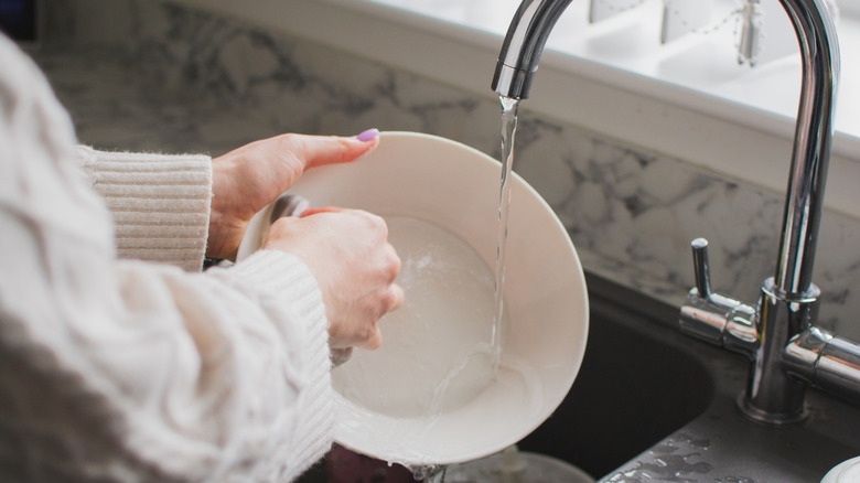 hands washing a bowl