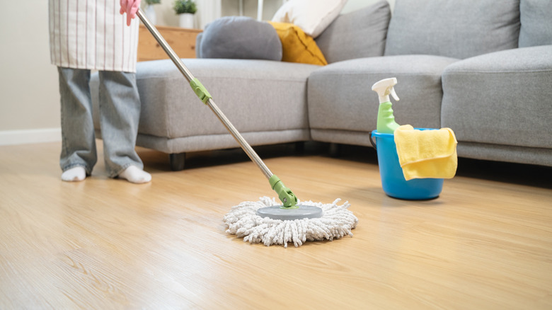 person mopping wood floor