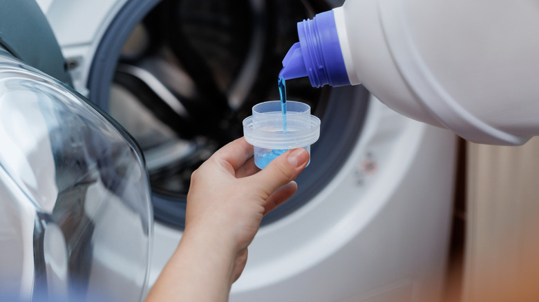 pouring laundry detergent