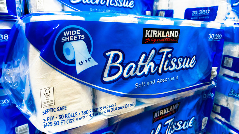 A large stack of toilet paper inside of a Costco store