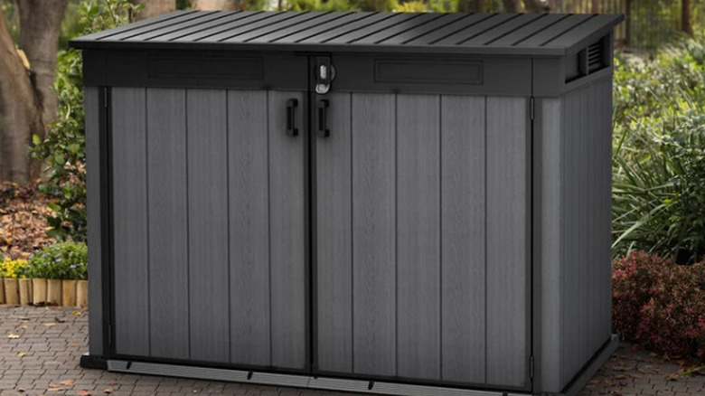 Keter Cortina Mega Premium Modern Horizontal Outdoor Storage Shed outside on patio
