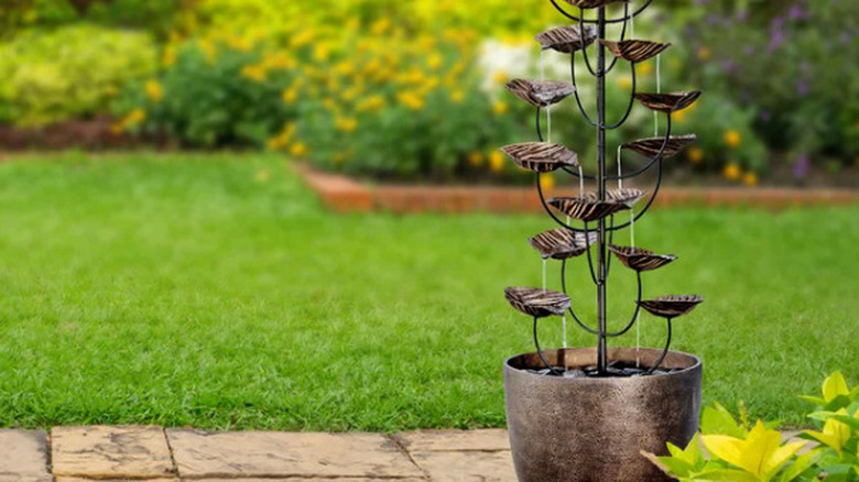 The Beaumont 60-inch CGH Cascading Leaves Fountain outside with a green lawn in the background
